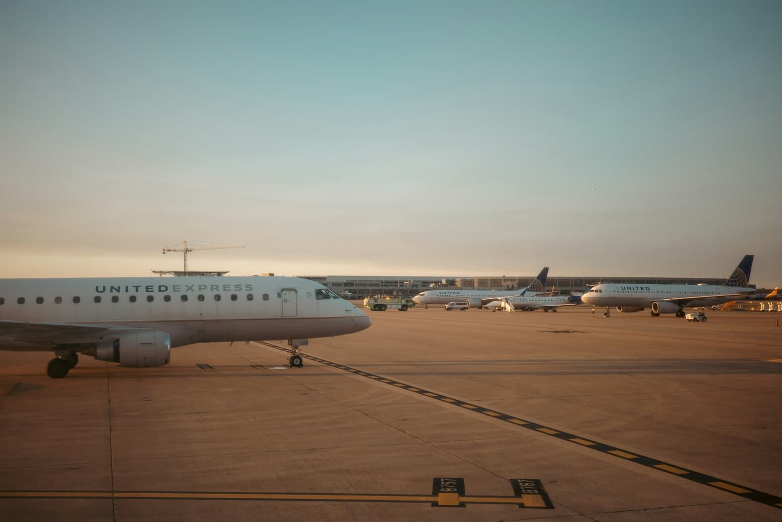 Airplanes parked on the apron during golden hour